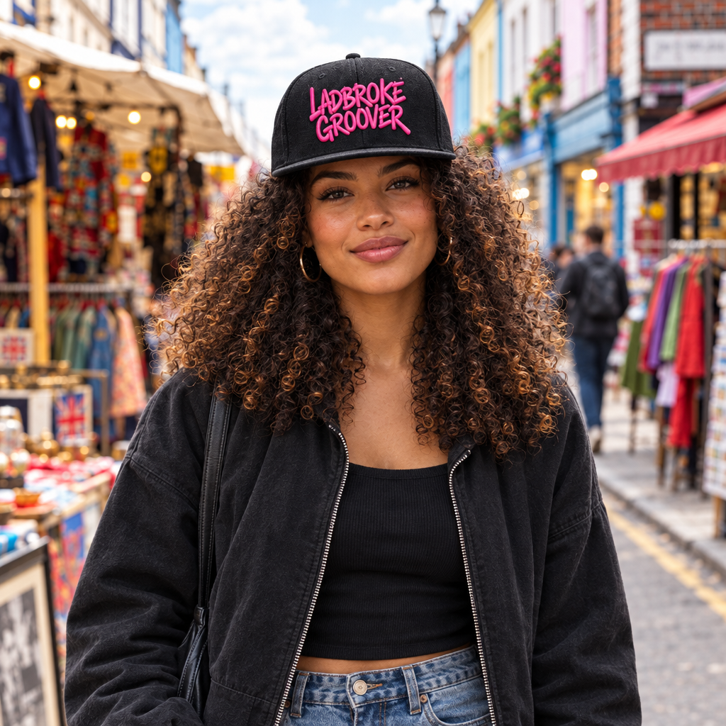 Woman walking on Portobello Road wearing pink-logo cap