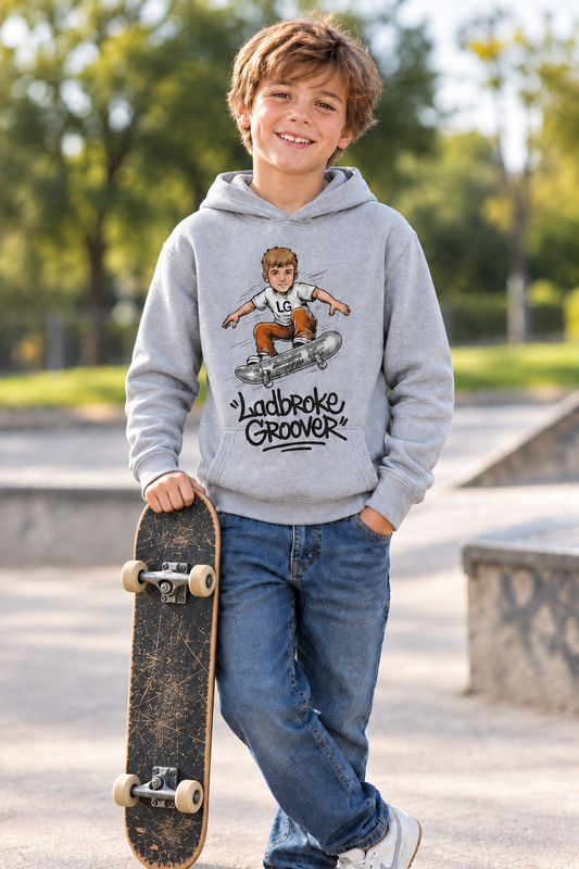 Boy holding a skateboard against his leg